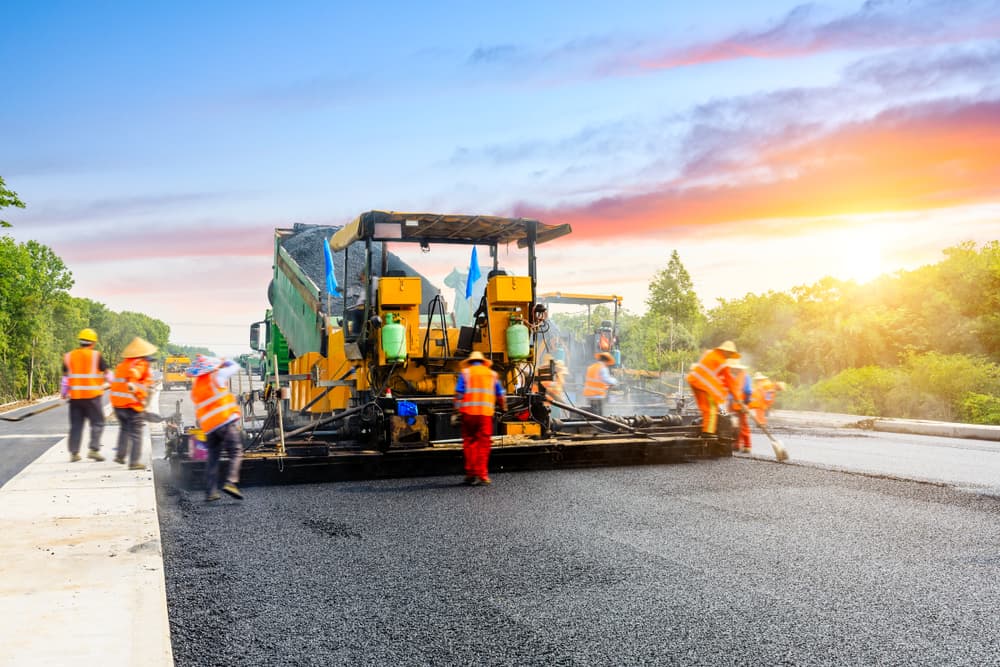 Illustration of a freshly paved asphalt driveway with a road roller