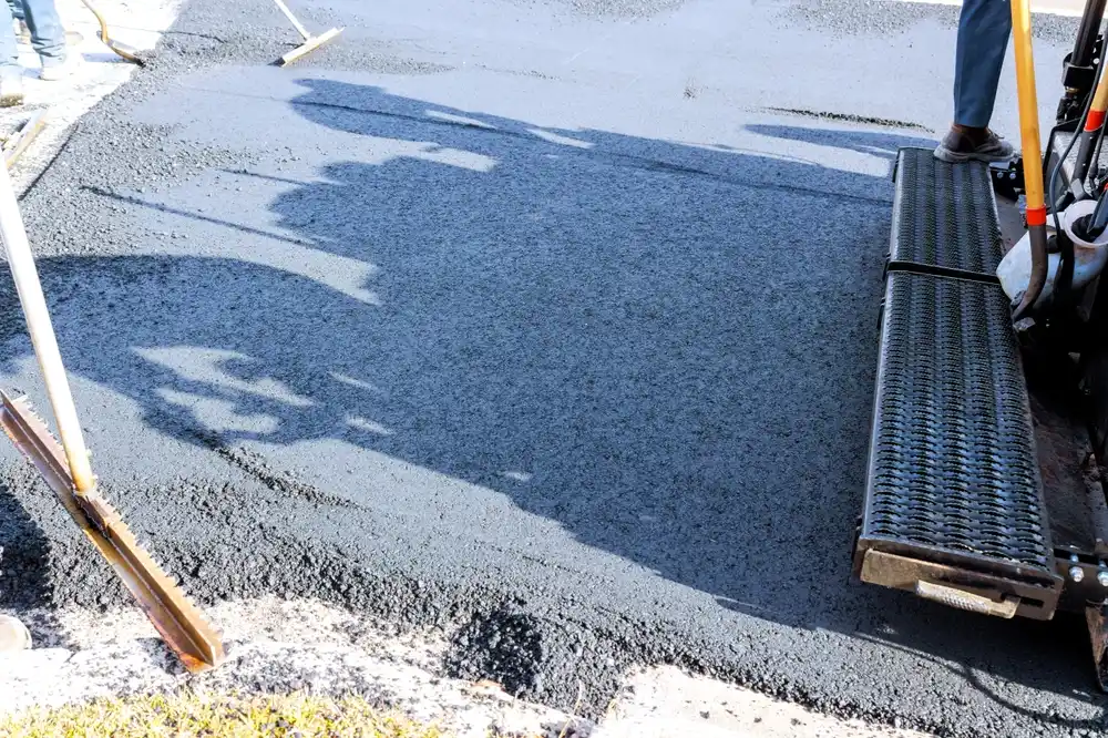 Illustration of a freshly paved asphalt driveway with a road roller