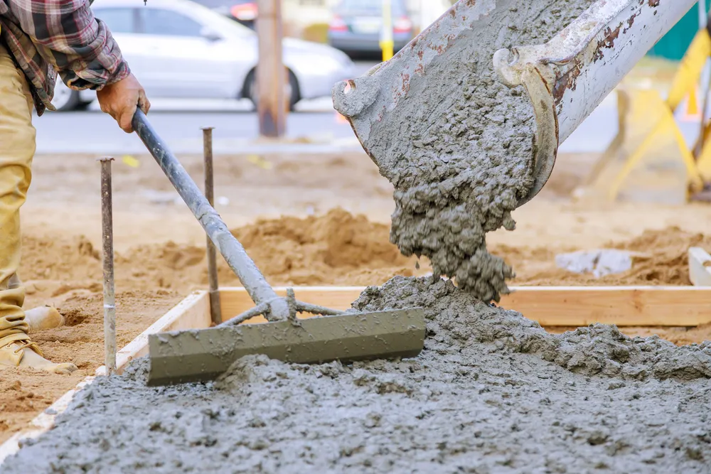 Illustration of a poured concrete patio with a wheelbarrow and mixer